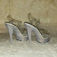 5" (132mm) Heel, 7/8" (25mm) Platform Comfort Width Ankle Strap Sandals Featuring Rhinestones Encrusted All-Over The Entire Platform Bottom Nicely Cushioned Comfort Width Foot-Bed New In Box Clear Heels With Rhinestones For Prom, Clear Heels With Rhinestones And Ankle Strap, Glamorous Sparkling Clear Heels, Clear Rhinestone High Heels, Glamorous Clear Heels With Rhinestones, Bedazzled Crystal High Heels, Crystal High Heels With Bling, High Heels With Rhinestones And Crystal Material, Crystal High Heels With Rhinestones