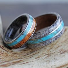 two wedding rings with turquoise and brown wood inlays on top of each other