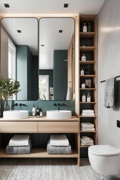 a bathroom with two sinks, a toilet and a large mirror