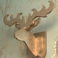 a deer head mounted to the side of a wall next to a clock on a wall