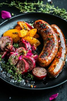 Grilled sausages with roasted vegetables garnished with fresh thyme on a black plate. Sausage Shop Design, Gourmet Sausage Recipes, Sausage Salad Recipe, Healthy Sausage Recipes, Sausage Meals, Sausage Salad, Gourmet Sausage, Sausage Recipes For Dinner, Bratwurst Sausage