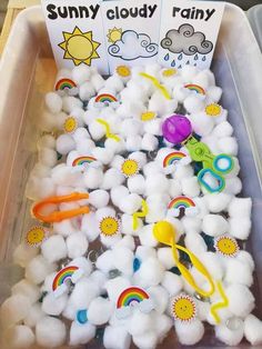 a bin filled with cotton balls, scissors and other items to make sunny clouds rainy