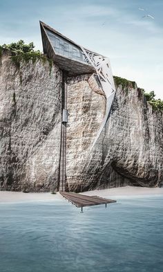 a boat floating on top of the ocean next to a large rock face covered in vegetation