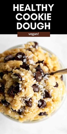 healthy cookie dough in a glass bowl with chocolate chips and coconut flakes on top