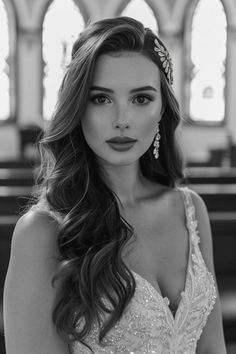 a beautiful woman in a wedding dress posing for the camera