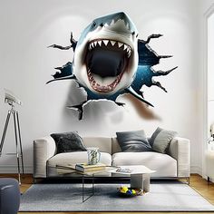 a shark with its mouth open and it's teeth out in the air above a couch