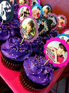 cupcakes with purple frosting and pictures on them