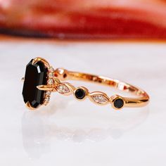 a black diamond ring sitting on top of a table