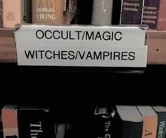 there is a sign that says occultmagic witches / vampires on the shelf