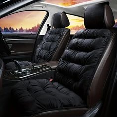 the interior of a car with black leather seats and an orange sky in the background