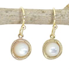 Pearl gold earrings, Simple Gemstone gold earrings ♥ ♥ ♥ Pearl- is the birthstone for the month of June, it symbolizes purity and is known as the "stone of sincerity". It is also the 3rd and 30th-year anniversary stone. 🌸 Product details: Handmade earrings 🌸 Measurements: Weight - 2.2 g Length - 1.02" (2.6 cm) Width - 0.35" (0.9 cm) Stone Diameter - 0.23" (6 mm) 🌸Materials: 14k gold plating (2 micron gold) over brass Mother of pearl 🌸 More info: All my jewelry is carefully wrapped and shippe 14k Yellow Gold Filled Earrings With Pearl Pendant, Yellow Gold Pearl Pendant Earrings 14k Gold Filled, Yellow Gold Earrings With Pearl Pendant, 14k Yellow Gold Pearl Pendant Earrings, Gold Pearl Earrings With 14k Ear Wire, Gold 14k Gold Pearl Earrings With Ear Wire, Gold Dangle Pearl Earrings As Gift, Dainty Round Pearl Pendant Earrings, Sterling Silver Yellow Gold Earrings With Pearl Pendant