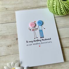 a card that says to my wedding husband on one wedding anniversary with two buttons attached