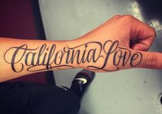 someone is holding their arm with the word california love on it