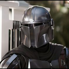 a man in a star wars costume is wearing a helmet