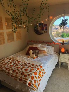 a bed room with a neatly made bed and a large round window overlooking the mountains