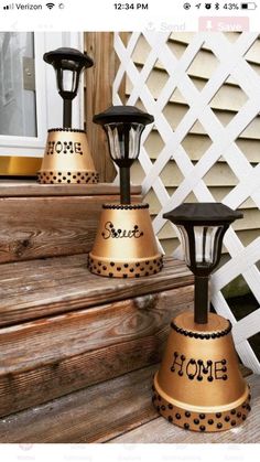 three black and gold lamps sitting on the steps