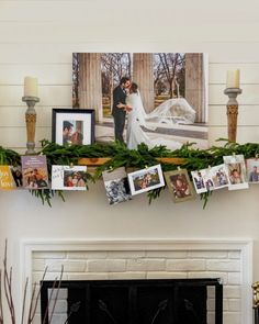 a mantel with pictures and candles on it next to a fire place in a living room