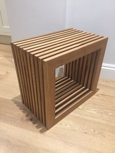 a wooden box sitting on top of a hard wood floor