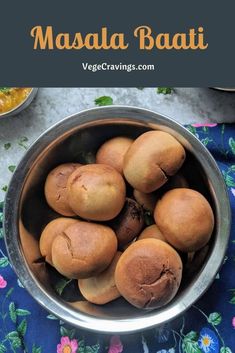 a metal bowl filled with food on top of a table