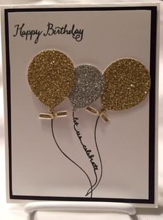 a happy birthday card with two balloons and the words happy birthday written in gold glitter