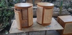 two wooden stools sitting next to each other on top of a piece of wood