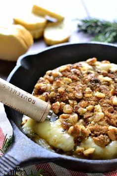 a skillet filled with baked potatoes and nuts