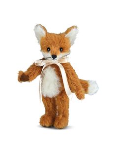 a small stuffed fox with a white ribbon around it's neck and eyes, standing upright