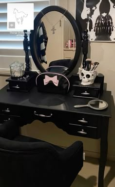 a desk with a mirror, skull mask and other items on it