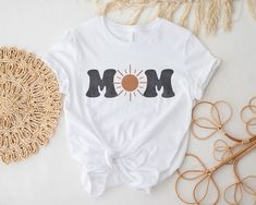 a mother's day t - shirt with the word mom on it next to some other items