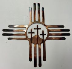 a metal clock with four crosses on it