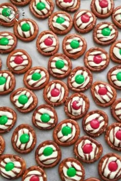 many cookies are decorated with white and green icing