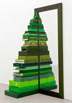 a green christmas tree made out of stacks of books