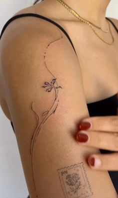 a woman with a tattoo on her arm