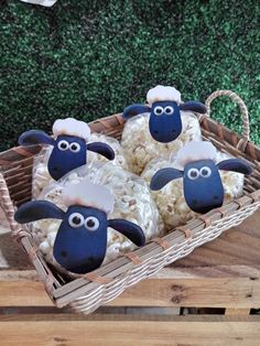 some sheep cookies sitting in a basket on a table