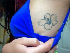 a woman with a flower tattoo on her stomach