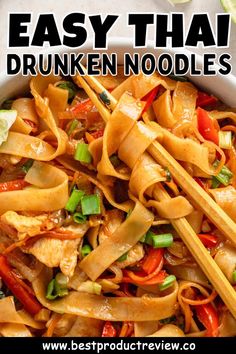 a bowl filled with noodles and vegetables next to chopsticks on the side that says easy thai drunken noodles