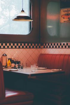 a restaurant with red booths and checkered walls