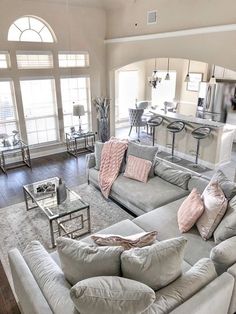 a living room filled with furniture and lots of windows in it's center area