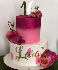 a pink and white cake with flowers on top is decorated with the number twenty one