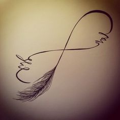 the word love is written in cursive writing on a wall with a feather