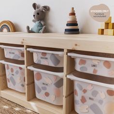 toy storage bins on top of a wooden shelf in a child's room