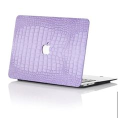 an apple laptop with purple crocodile skin on the cover is shown in front of a white background