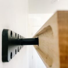 a wooden object is hanging on the wall