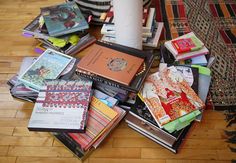 a pile of books sitting on top of a wooden floor