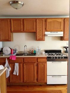 a kitchen with wooden cabinets and white appliances