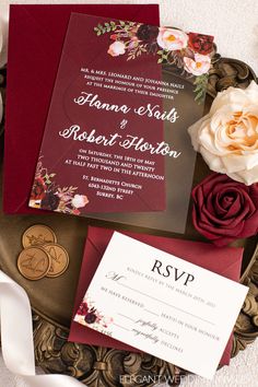 the wedding stationery is laid out on top of a plate with flowers in it