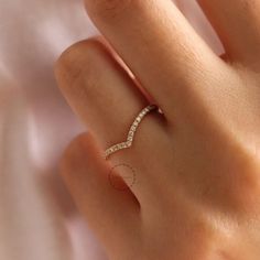 a woman's hand with a diamond ring on top of her finger and the word love written across it