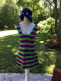 "This is one funky little mini from the 70's. The fabric is a poly/jersey blend and the design is bold colored stripes...hot pink, lime green and royal blue. Scoop necked with zipper down back. It could be worn as a mini dress or as a fun top with leggings. Hand made many years ago, still in nice wearable shape. Measurements: 36\" bust; mid body 33\"; 38\" hips; 51\" hemline; 32 1/2\" tall. Thanks for stopping by my Etsy shop!" Retro Stretch Sleeveless Mini Dress, Retro Stretch Mini Dress For Summer, Vintage Cotton Mini Dress, Vintage Blue Cotton Mini Dress, Retro Stretch Mini Dress, Vintage Blue Mini Dress For Summer, Playful Cotton Mini Dress For Summer, Retro Blue Mini Dress, Retro Striped Mini Dress