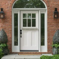 a white front door on a brick house