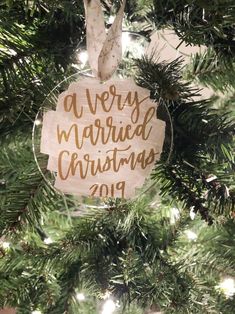 a merry married christmas ornament hanging on a tree